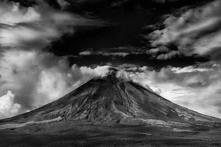 gray scale photo of active volcano